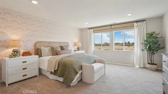 a bedroom with a large bed and a large window