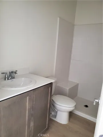 a white toilet sitting next to a bathroom sink