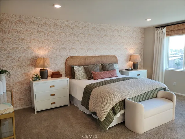 a bedroom with a bed and a night stand