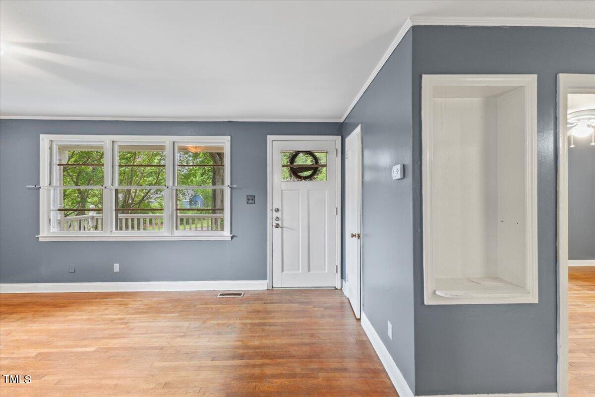 2324 Stevens Road Raleigh, NC 27610 - Photo 11 of 50 a view of an empty room with wooden floor and a window