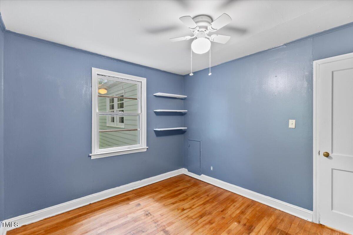 2324 Stevens Road Raleigh, NC 27610 - Photo 16 of 50 an empty room with a window and chandelier fan
