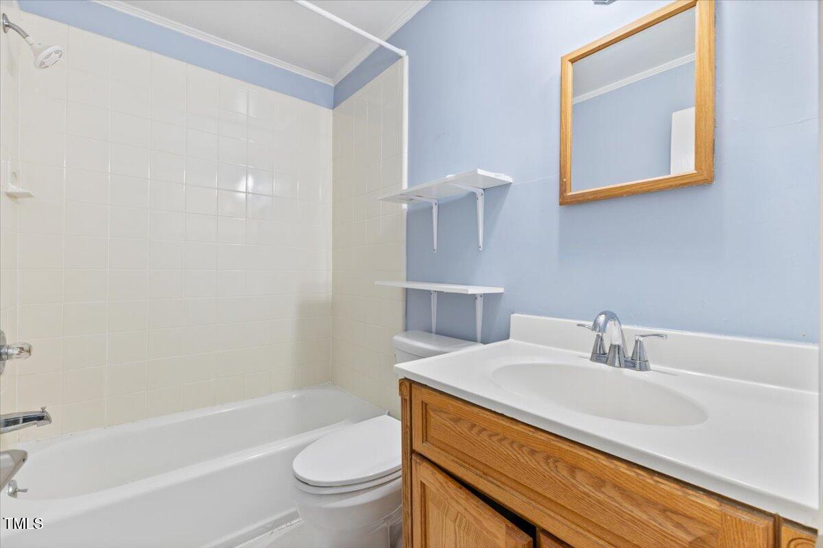 2324 Stevens Road Raleigh, NC 27610 - Photo 17 of 50 a bathroom with a sink a toilet and shower