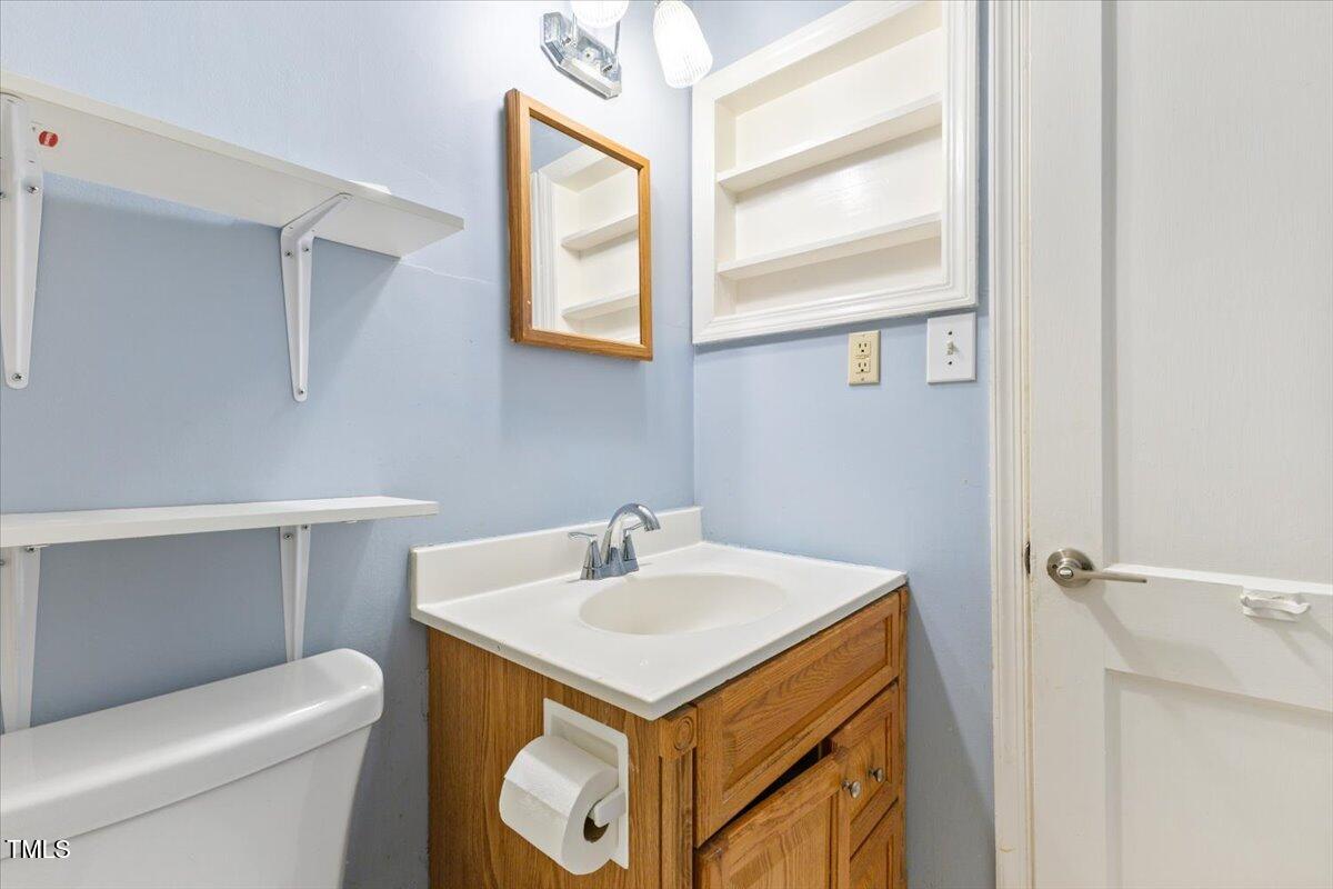 2324 Stevens Road Raleigh, NC 27610 - Photo 18 of 50 a bathroom with a sink toilet and mirror