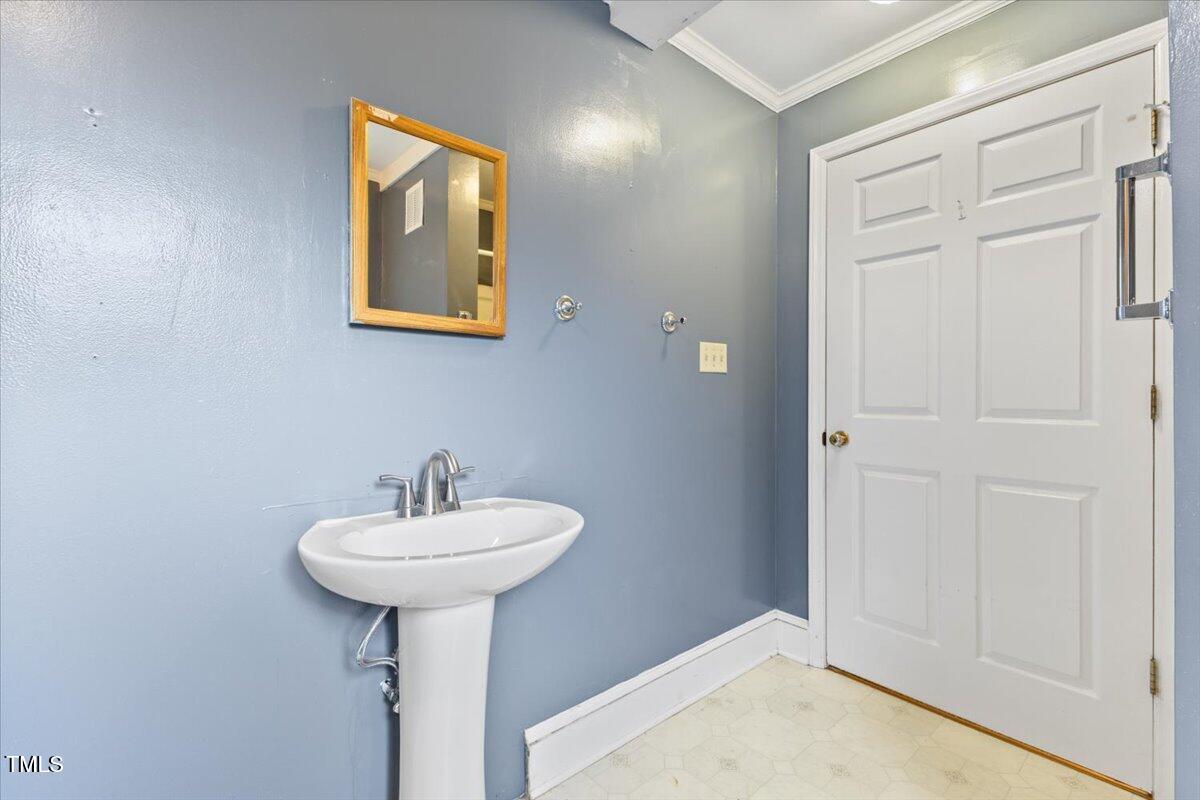 2324 Stevens Road Raleigh, NC 27610 - Photo 30 of 50 a bathroom with a sink and a mirror