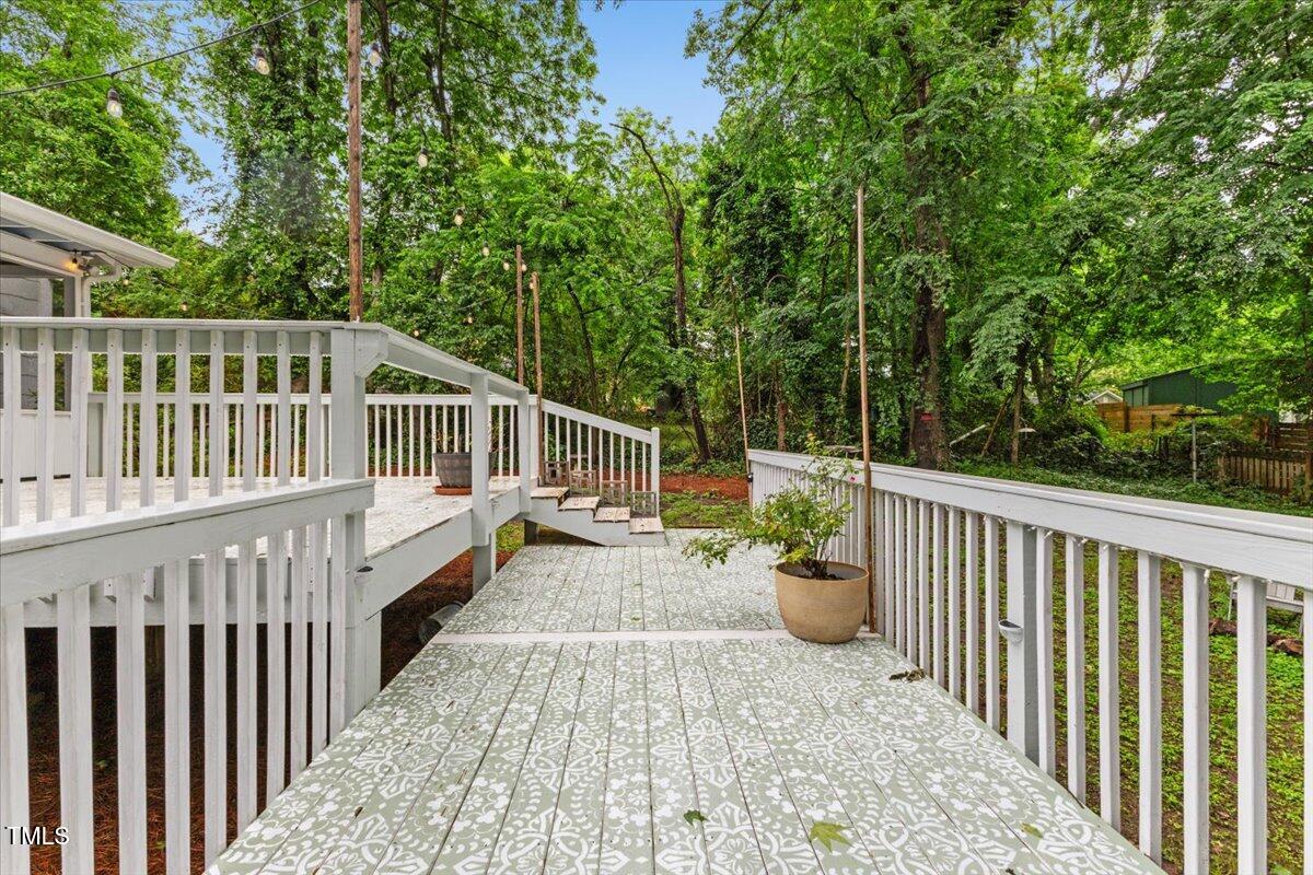 2324 Stevens Road Raleigh, NC 27610 - Photo 42 of 50 a view of a chair and table on the wooden deck