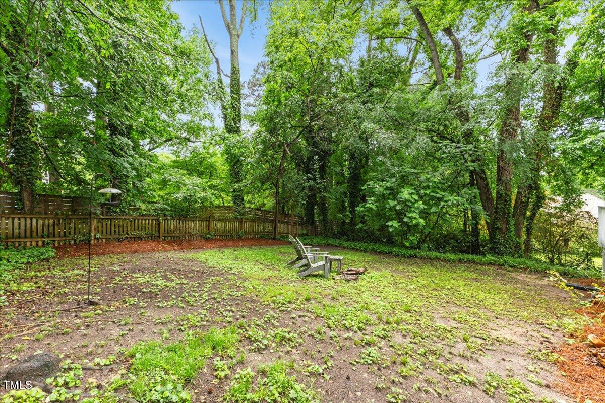 2324 Stevens Road Raleigh, NC 27610 - Photo 44 of 50 a backyard of a house with lots of green space and fountain