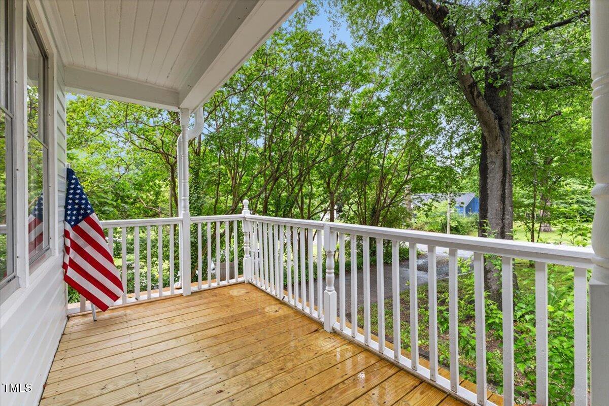 2324 Stevens Road Raleigh, NC 27610 - Photo 6 of 50 a balcony with wooden floor and trees in the back