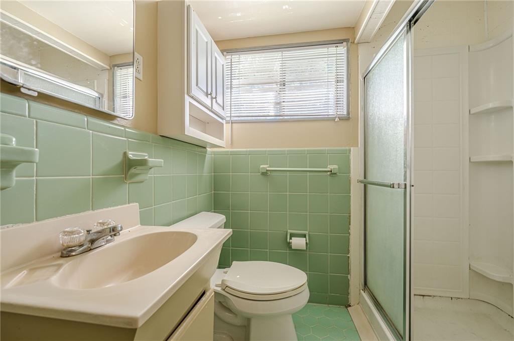 1502 North Druid Hills Road Brookhaven, GA 30319 - Photo 24 of 46 a bathroom with a sink toilet and shower