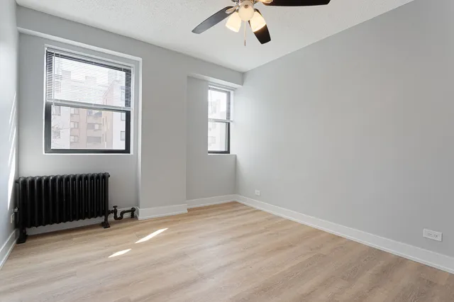 an empty room with windows and closet