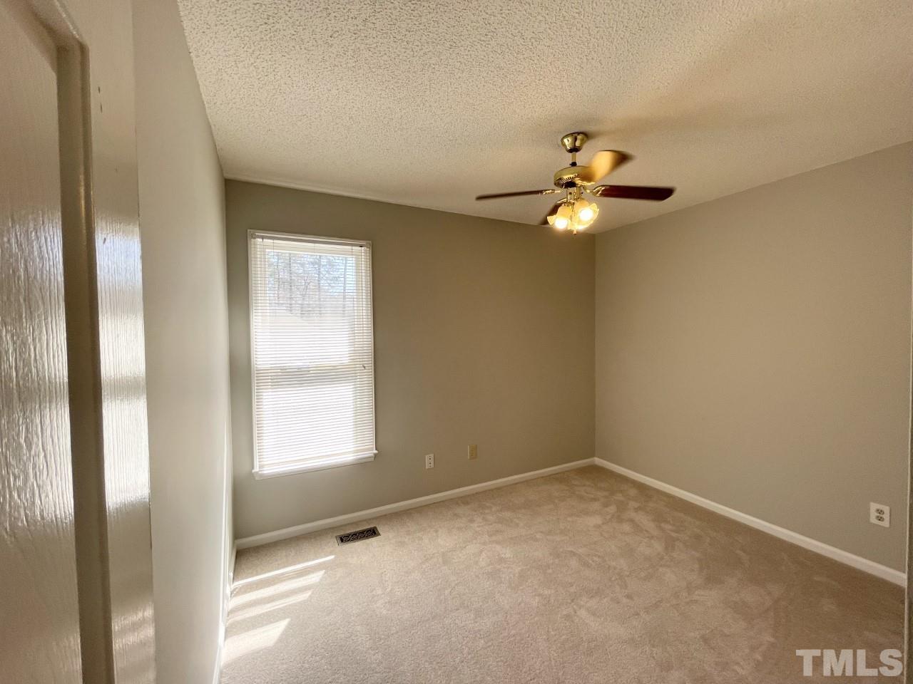 208 Crosspine Drive Raleigh, NC 27603 - Photo 13 of 40 First bedroom down the hall on the right. Window looks out to front yard.