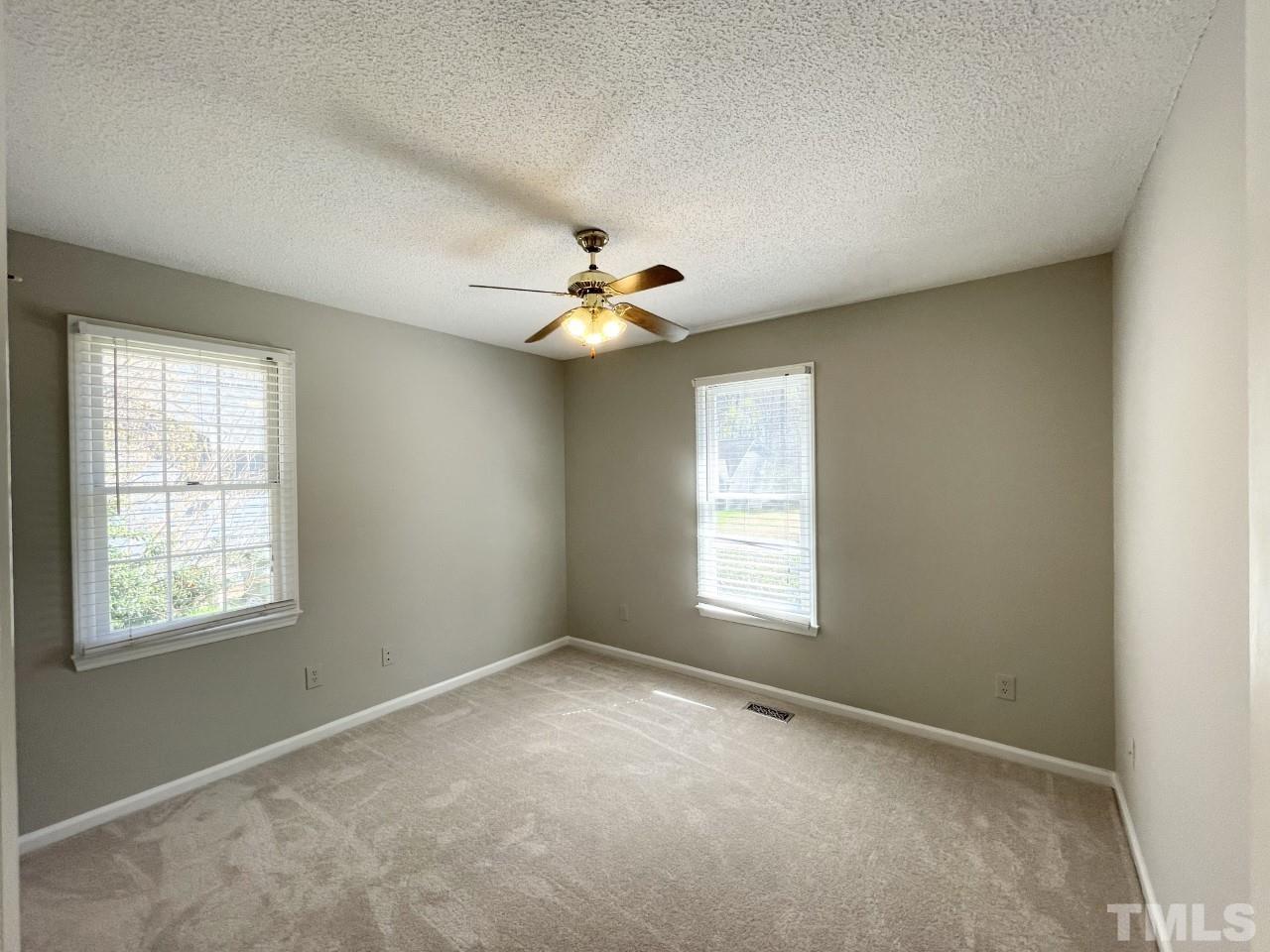 208 Crosspine Drive Raleigh, NC 27603 - Photo 15 of 40 Second bedroom on right, windows look out to front yard and side yard.