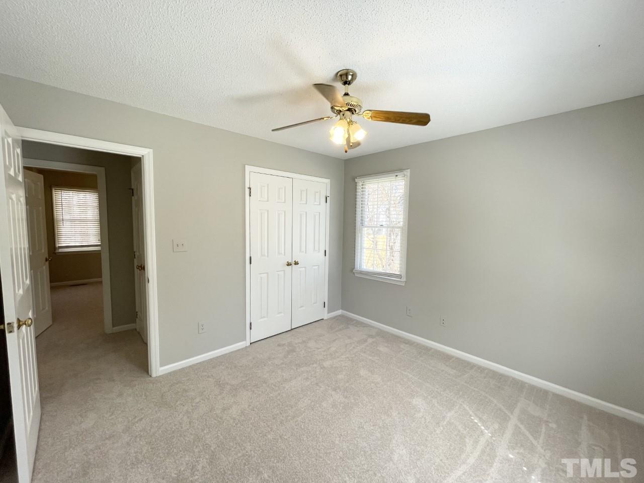 208 Crosspine Drive Raleigh, NC 27603 - Photo 16 of 40 Second bedroom on right, view of closet.