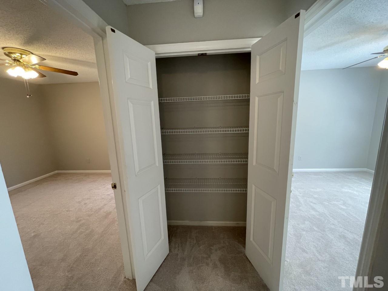208 Crosspine Drive Raleigh, NC 27603 - Photo 17 of 40 At the end of the hall, between the second bedroom on right and the owner's suite on left.
