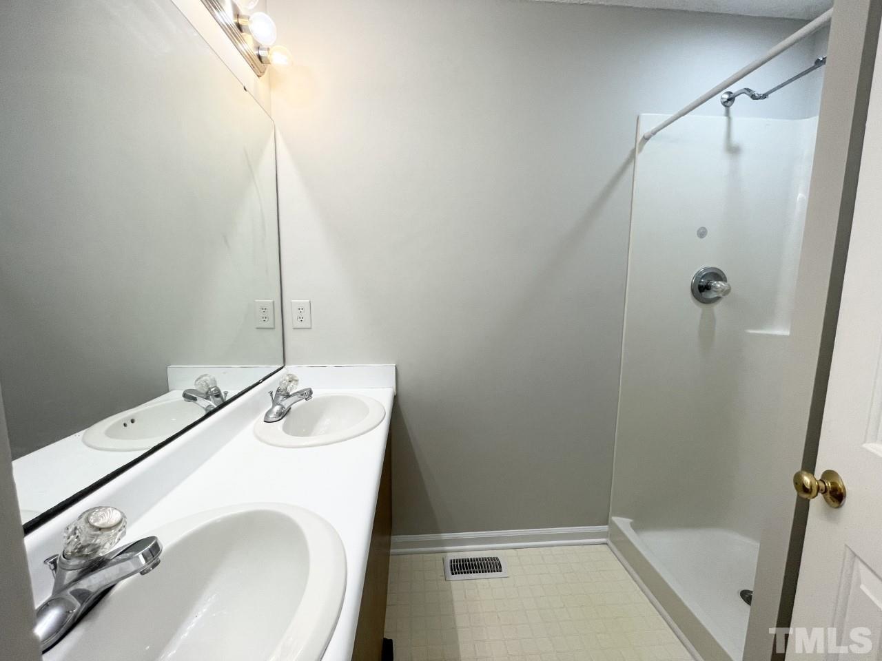 208 Crosspine Drive Raleigh, NC 27603 - Photo 20 of 40 Double vanity, single shower with rainshower head, toilet behind bathroom door.