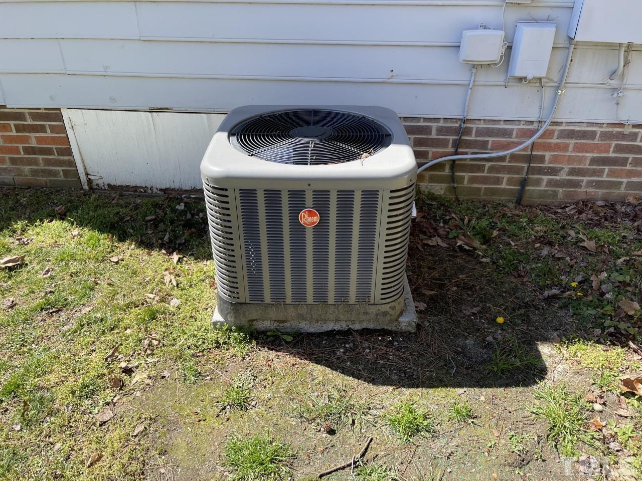 208 Crosspine Drive Raleigh, NC 27603 - Photo 34 of 40 A/C unit (2019) next to crawl space access.