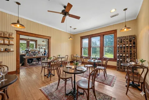 a dining room with furniture and wooden floor