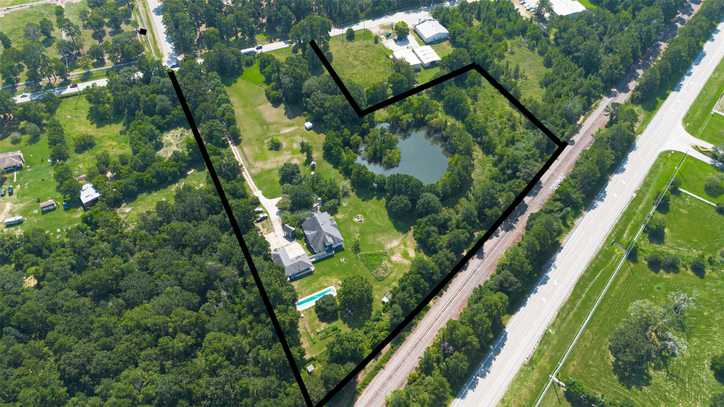 38011 Spur 149 Road Magnolia, TX 77354 - Photo 2 of 40 A new survey will be needed to verify the exact boundaries of the property. Notice the land on the other side of the pond. You could use it to create adorable tiny homes for your guests and family, giving them their own private areas.