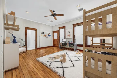 a spacious bedroom with a large bed and a chandelier
