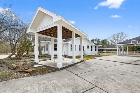 a front view of house with a garden and patio