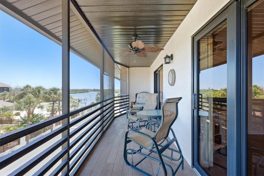 2729 North Beach Road, Unit 211 Englewood, FL 34223 - Photo 38 of 51 a balcony view with a table and chairs