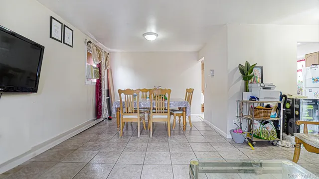 a dining room with furniture and a flat screen tv