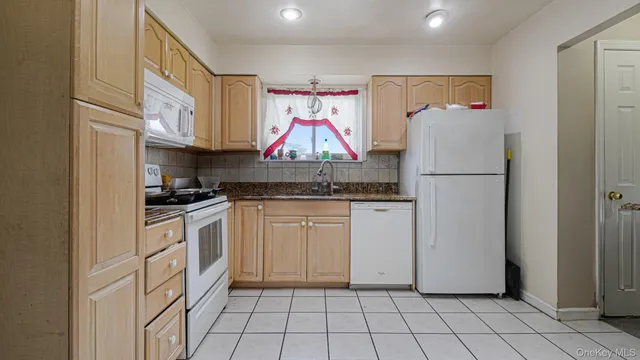 a kitchen with appliances cabinets and furniture