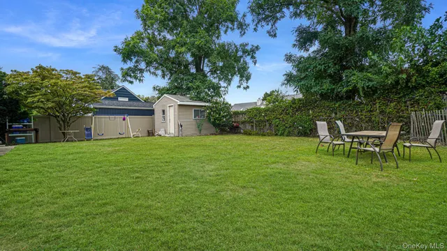 a backyard of a house with table and chairs