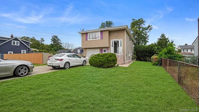 a view of a house with a garden and parking space