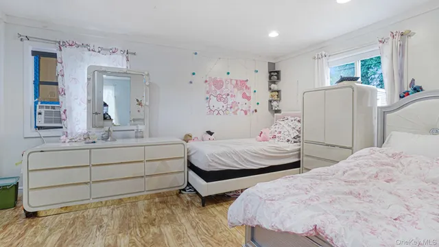 a bedroom with two beds and painting on the wall