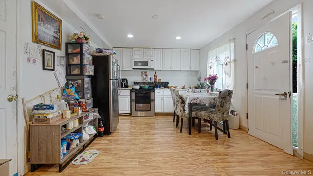 a view of a dining room with furniture and a kitchen