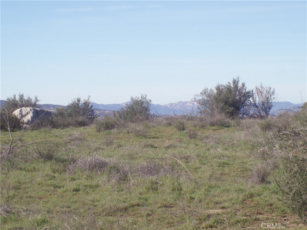 0 Linderman Road Hemet, CA 92544 - Photo 2 of 12 a view of a dry field with trees in background