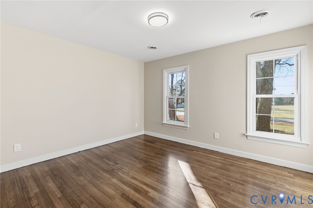 9924 Reams Road Chesterfield, VA 23236 - Photo 15 of 30 an empty room with wooden floor and windows