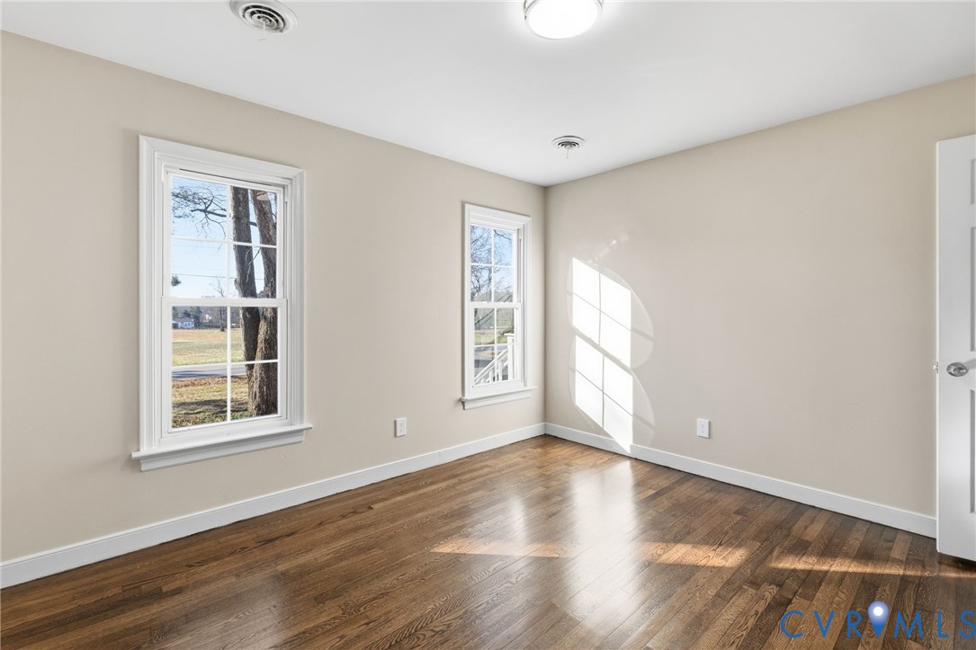 9924 Reams Road Chesterfield, VA 23236 - Photo 18 of 30 a view of an empty room with wooden floor and a window