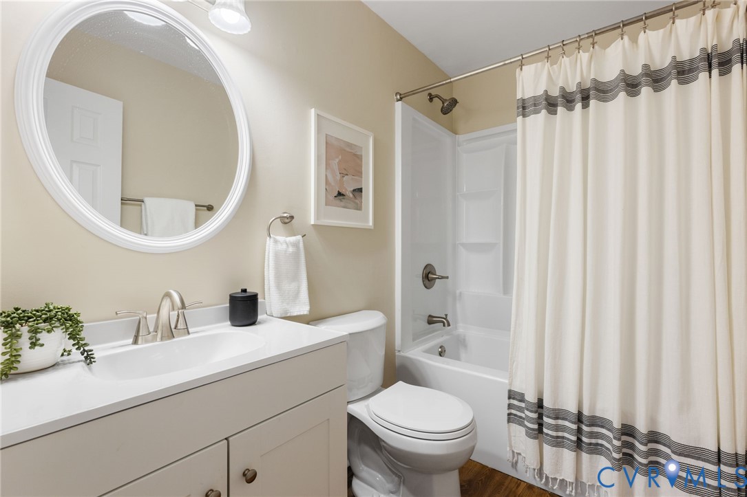 9924 Reams Road Chesterfield, VA 23236 - Photo 19 of 30 a bathroom with a sink a toilet and a mirror