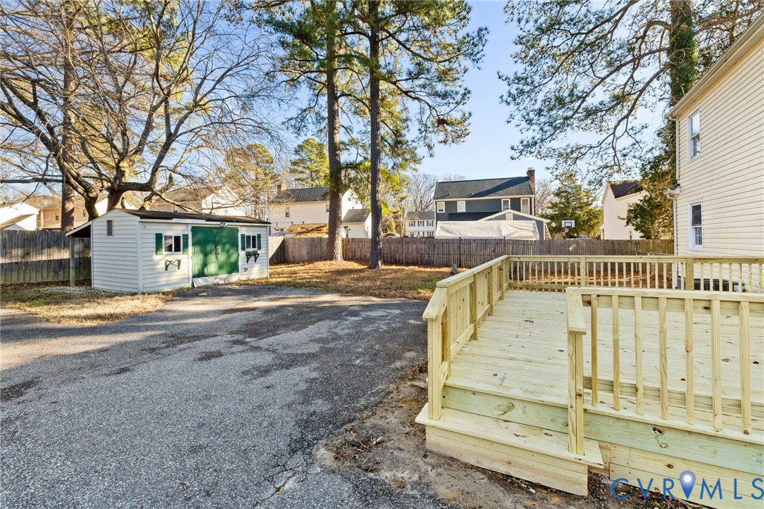 9924 Reams Road Chesterfield, VA 23236 - Photo 27 of 30 a view of a house with a large tree and wooden fence