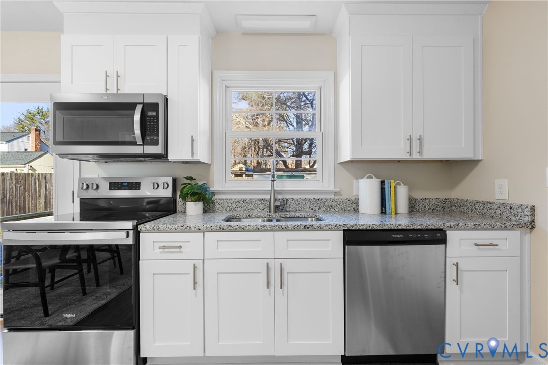 9924 Reams Road Chesterfield, VA 23236 - Photo 3 of 30 a kitchen with stainless steel appliances granite countertop a stove a sink and a microwave