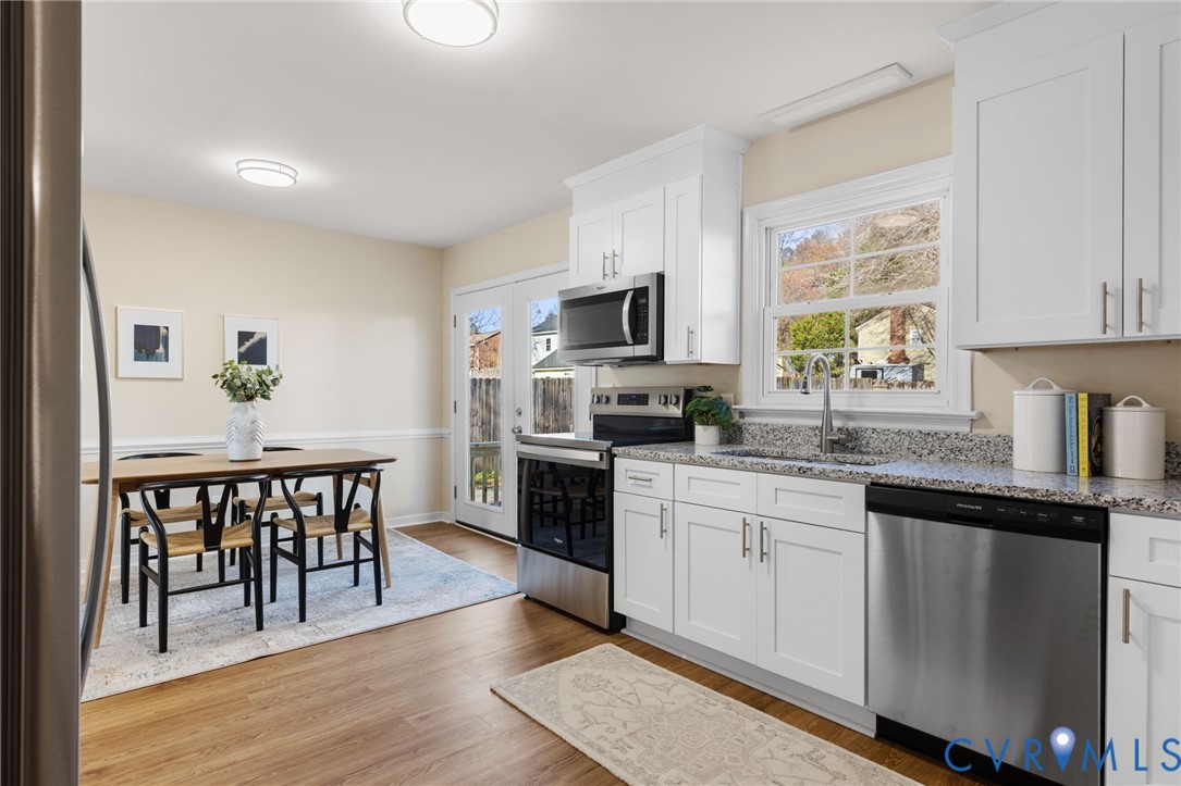 9924 Reams Road Chesterfield, VA 23236 - Photo 4 of 30 a kitchen with granite countertop a stove top oven microwave and cabinets