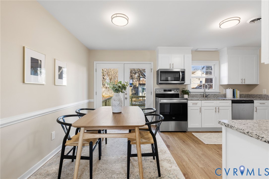 9924 Reams Road Chesterfield, VA 23236 - Photo 6 of 30 a kitchen with granite countertop white cabinets and stainless steel appliances