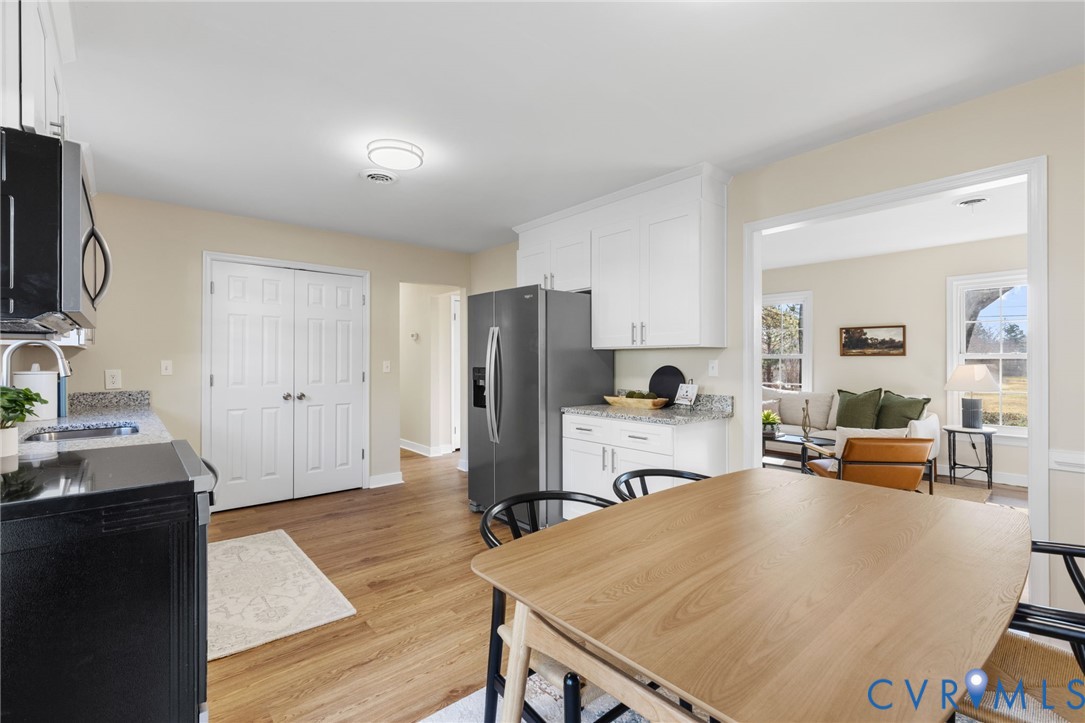 9924 Reams Road Chesterfield, VA 23236 - Photo 9 of 30 a living room with stainless steel appliances a stove a sink a refrigerator white cabinets and furniture