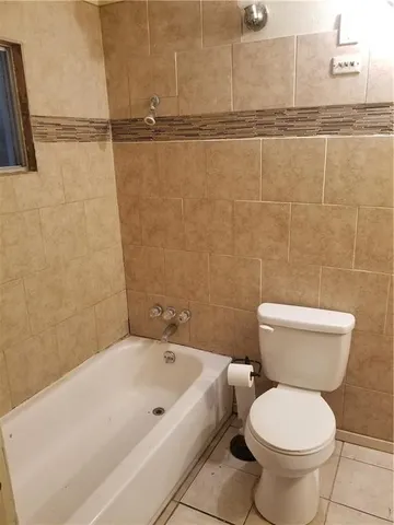 a bathroom with a toilet and a bathtub