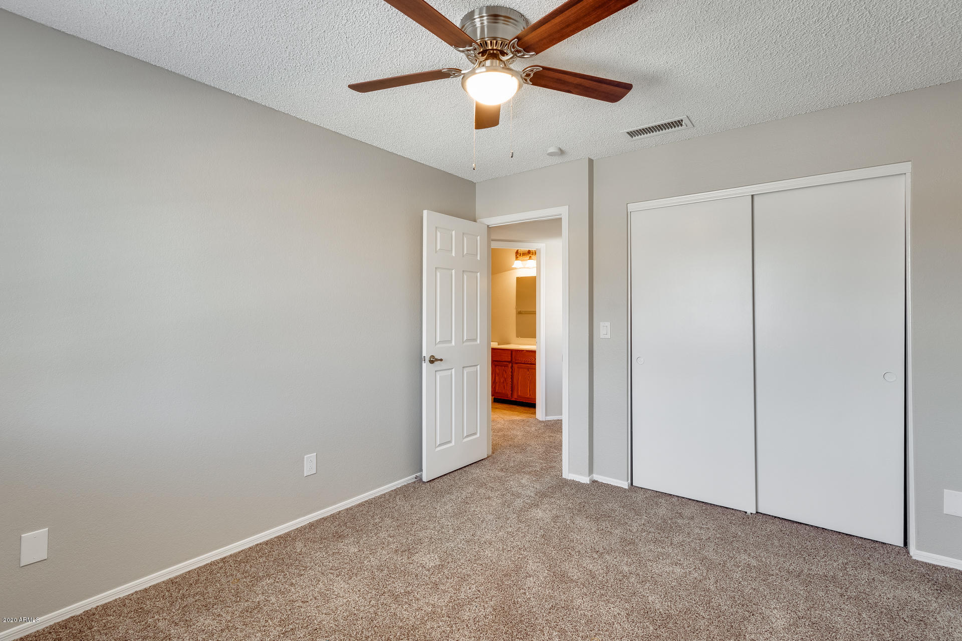 4157 East Agave Road Phoenix, AZ 85044 - Photo 27 of 33 an empty room with closet and a chandelier fan