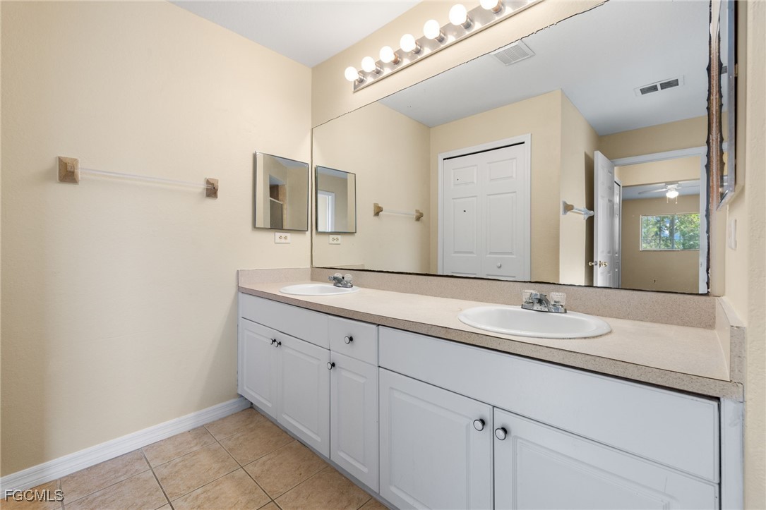 3733 16th Street West Lehigh Acres, FL 33971 - Photo 13 of 25 a bathroom with a double vanity sink and a mirror