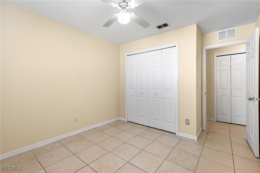 3733 16th Street West Lehigh Acres, FL 33971 - Photo 16 of 25 a view of an empty room with window and chandelier fan