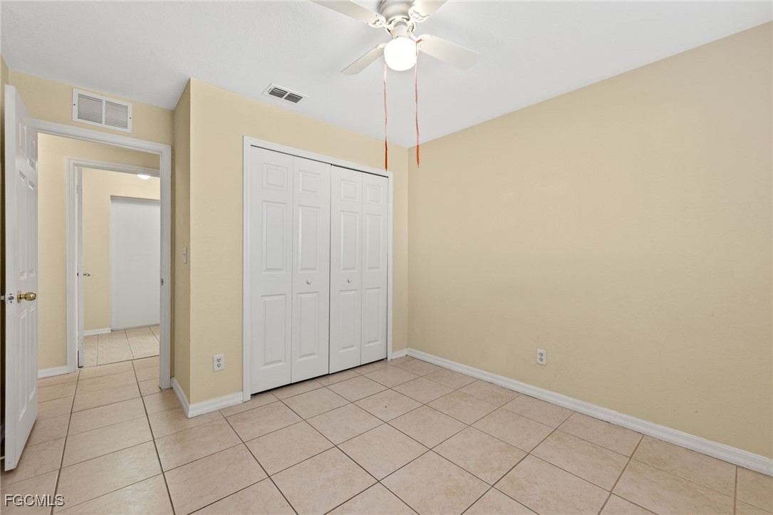 3733 16th Street West Lehigh Acres, FL 33971 - Photo 19 of 25 a view of a room with a chandelier fan and closet area