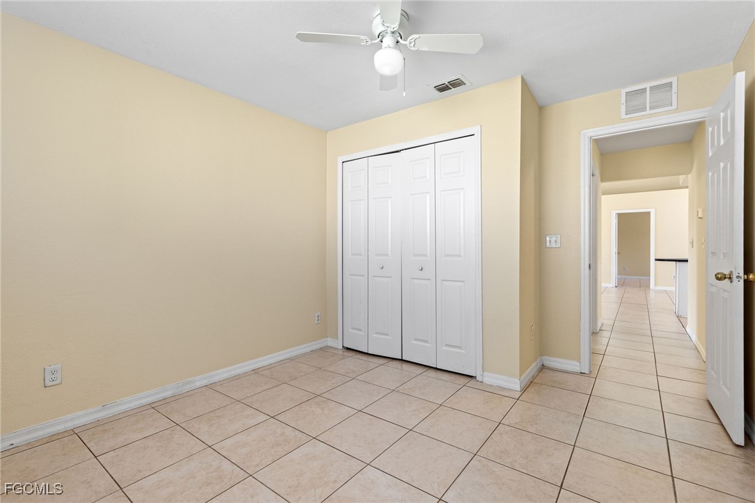 3733 16th Street West Lehigh Acres, FL 33971 - Photo 21 of 25 an empty room with closet and a chandelier fan