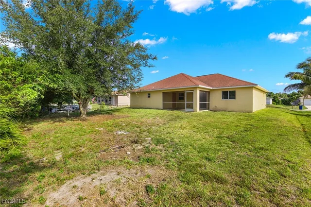 a front view of house with yard and trees