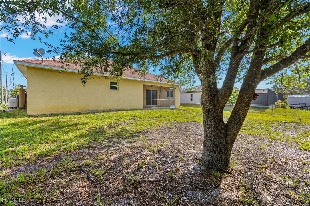 3733 16th Street West Lehigh Acres, FL 33971 - Photo 25 of 25 a front view of house with yard and trees