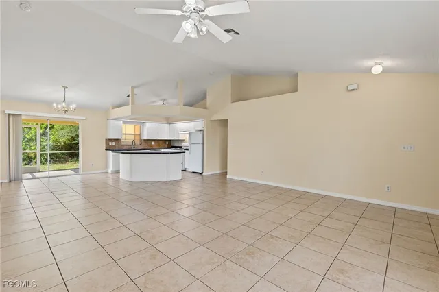 a view of a kitchen with furniture and a stove top oven