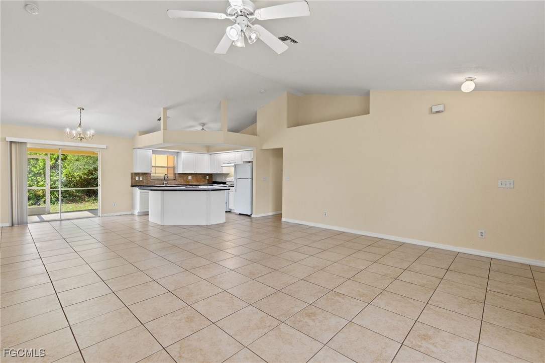 3733 16th Street West Lehigh Acres, FL 33971 - Photo 3 of 25 a view of a kitchen with furniture and a stove top oven