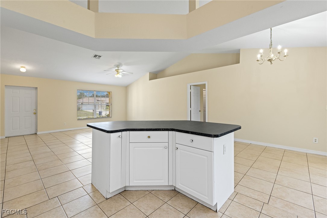 3733 16th Street West Lehigh Acres, FL 33971 - Photo 8 of 25 a kitchen with granite countertop white cabinets and white appliances